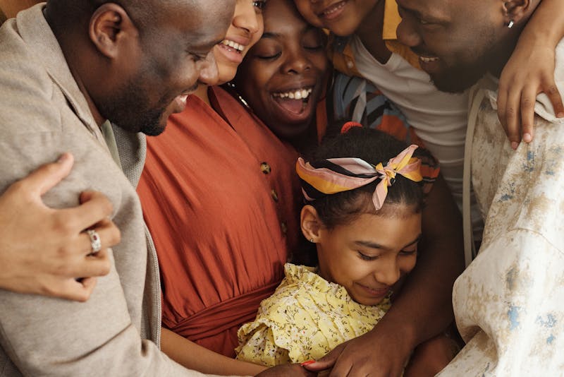 Family hugging one another.